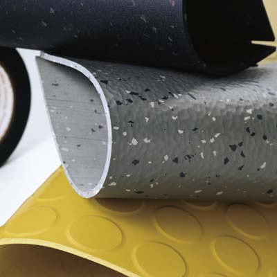 stacked samples of rubber floor tiles in many patterns and colors