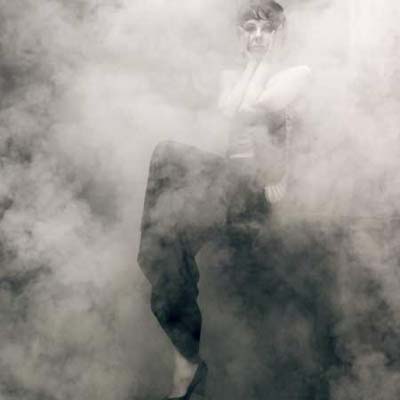 woman sitting in smoky room