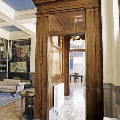terra-cotta floor tiles, marble baseboards, and pink granite wall slabs in post office turned into home