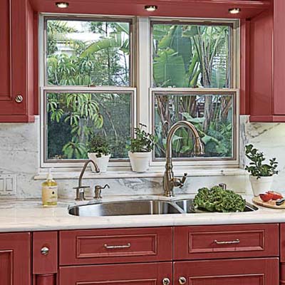 sink with marble countertops, backsplash, and behind-the-sink windowsill