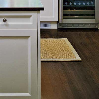 hardwood floors offer a handsome contrast to a mostly white kitchen