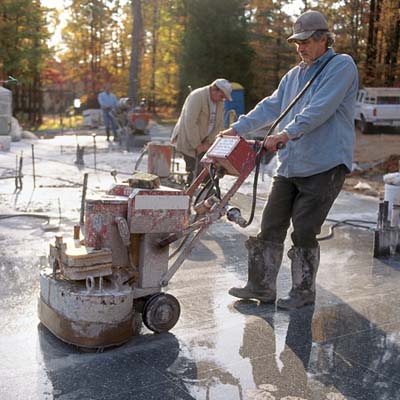 man grinding surface of the floor