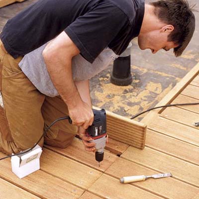 man installing composite decking