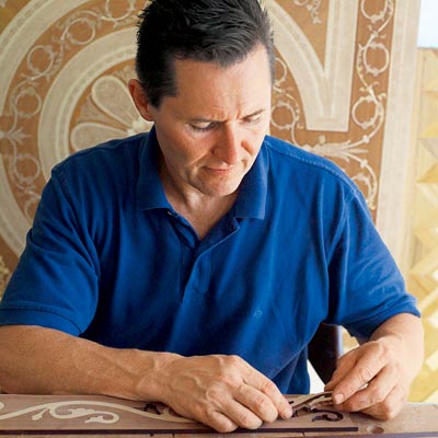 flooring craftsman, Charles Peterson assembling a handmade border for a wood floor