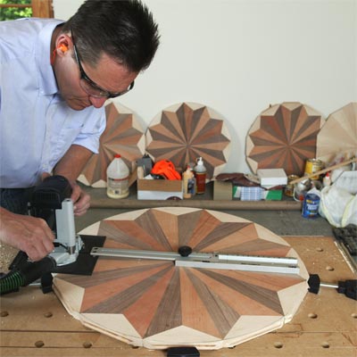 flooring craftsman, Charles Peterson assembling a wooden floor medallion