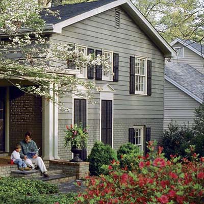 a closeup of a house with windows made over and a spruced-up front yard