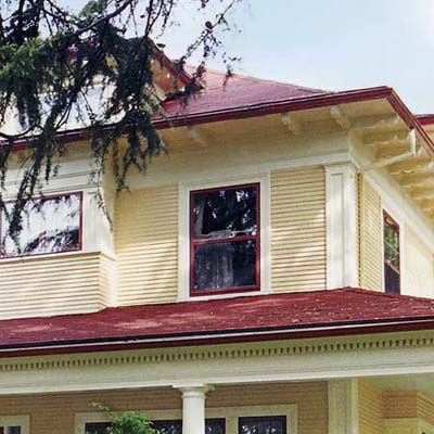 a closeup on a house with new roof, new paint job and a front yard makeover 