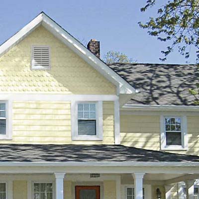 a closeup of a house with new siding and roof shingles
