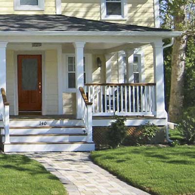 a closeup of a house with a porch and front lawn makeover