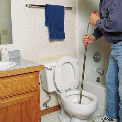 repairing a clogged toilet