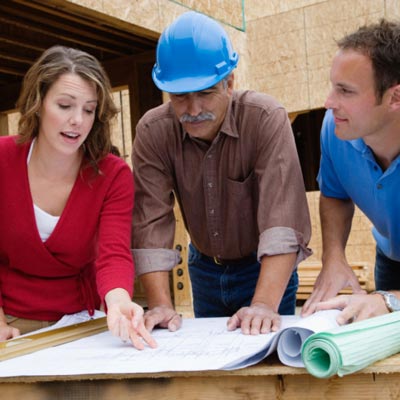 couple looking at plans with contractor