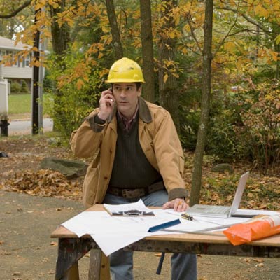 contractor on phone looking at plans