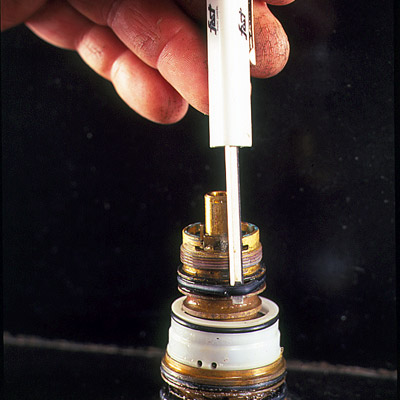 man replacing o rings of faucet