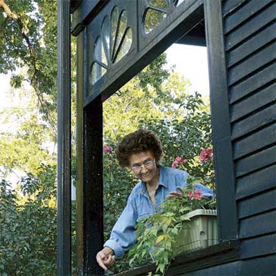 a homeowner tending to her flowers in detroit michigan's best old house neighborhood