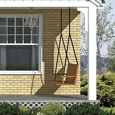 a porch swing is added in the photoshop redesign of this ranch style house
