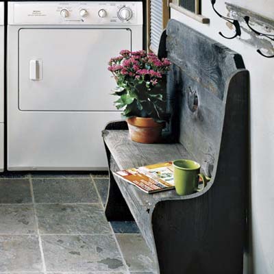 mudroom laundry area with slate floor and wood bench