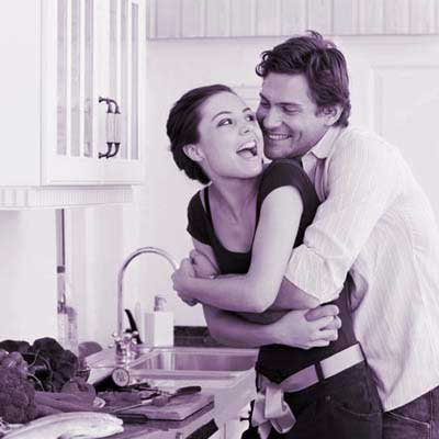 man and woman hugging in kitchen