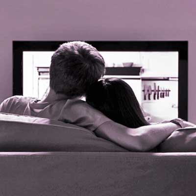 man and woman watching tv