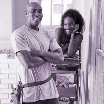 woman gazing at man in tool belt