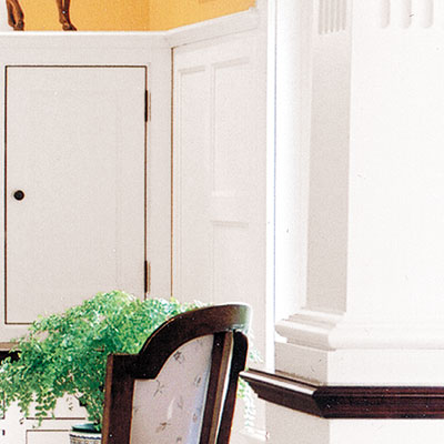 home office with traditional colonnades and wainscoting
