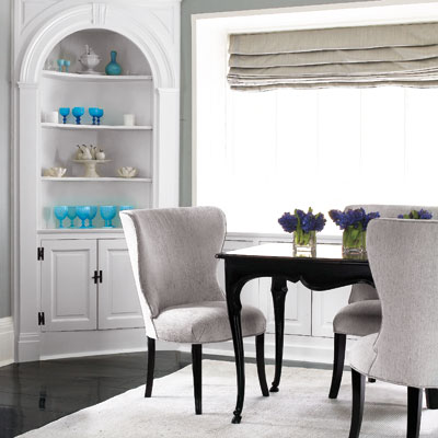 dining room in neutral tones with dark wood table in serene home
