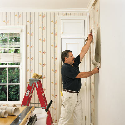 man installing wallpaper