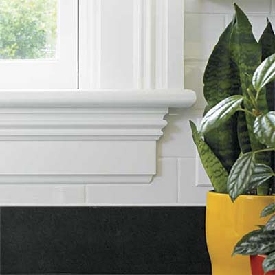 windows trimmed to match other existing windows and blend with subway tile in this remodeled italianate kitchen