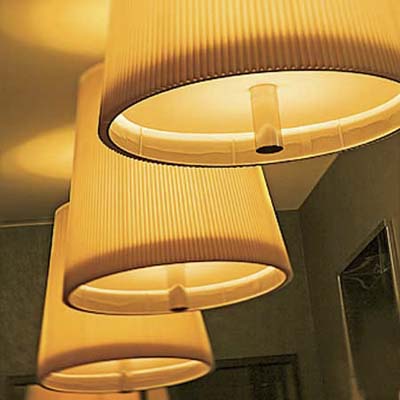 four hanging shades from a row of lit pendant lights