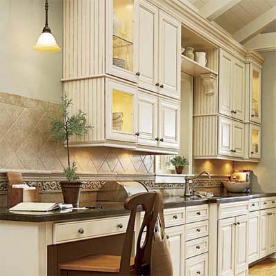 pendant hung beside a bank of upper cabinets illuminating the countertop beneath