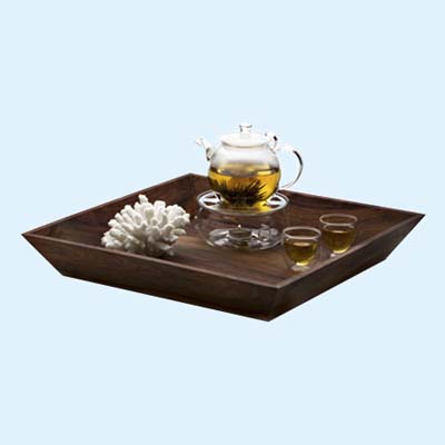 glass tea pot and cups on rosewood serving tray