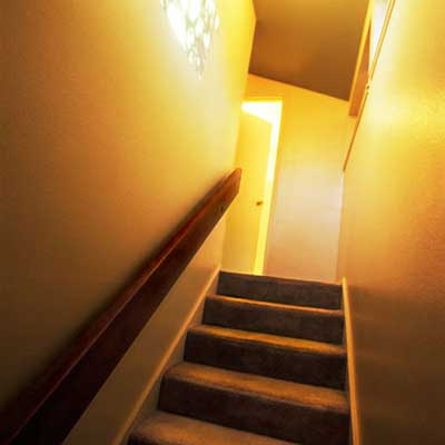 imposing looking narrow stairway leading up to a door