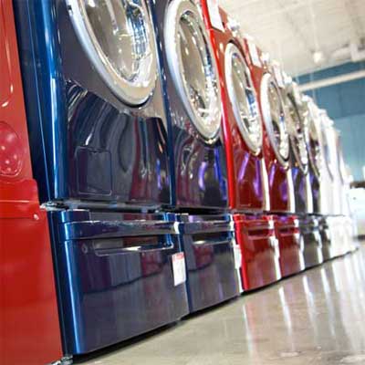 long row of shiny and brightly colored washer dryers