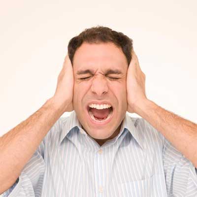person screaming with hands clamped over their ears