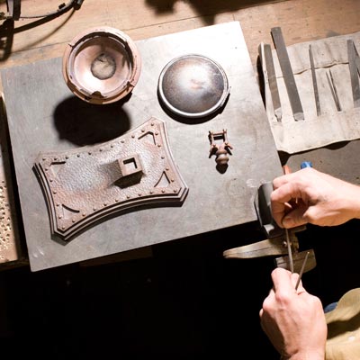 lighting fixture designer looking at metal products