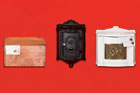 3 wall-mount mailboxes against red background