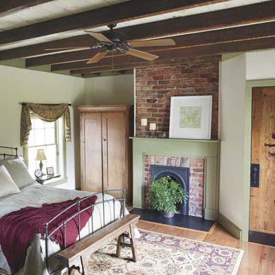 newly finished bedroom with new fireplace and pine floors