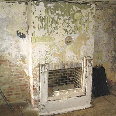 Purcell house kitchen with decrepit fireplace before remodel