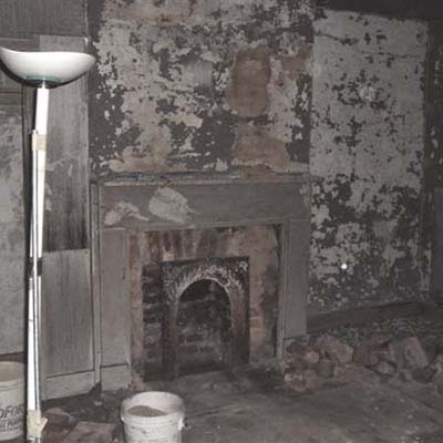 bathroom fireplace before renovation with crumbling fixtures
