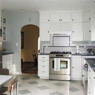 updated kitchen with tiled floor and white cabinets