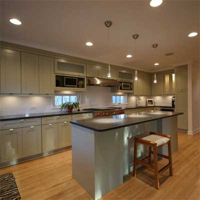updated kitchen with track lighting and wood floor