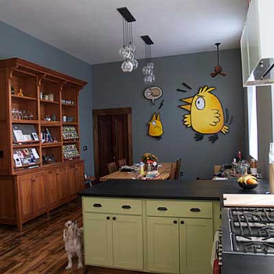 updated kitchen with painted bird motif on wall
