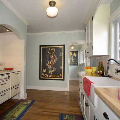 remodeled kitchen with blue walls and white cabinetry