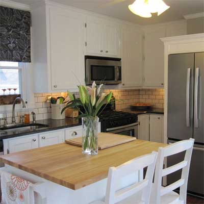 updated kitchen with butcher block and white cabinetry