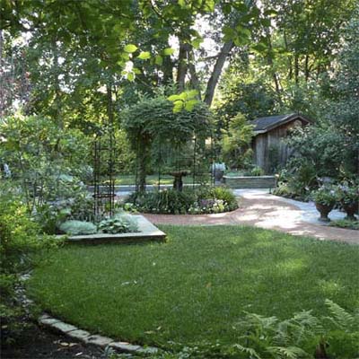 manicured back lawn with brick path