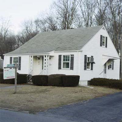 small white house with dried out front lawn