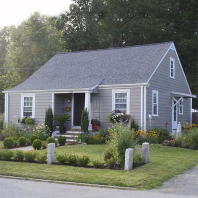 remodeled house with manicured front lawn