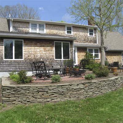 manicured backyard with stone wall