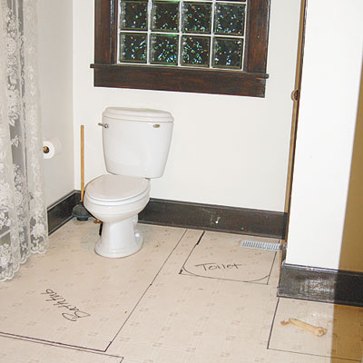outdated bathroom with unfinished floor