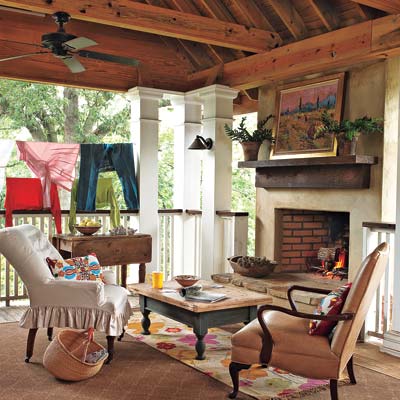 remodeled cottage with covered second story porch with fireplace
