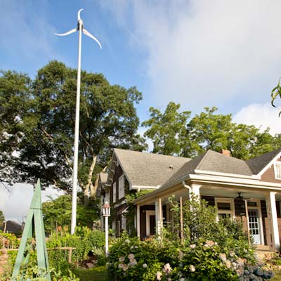 wind mill installed outside of eco friendly cottage remodel
